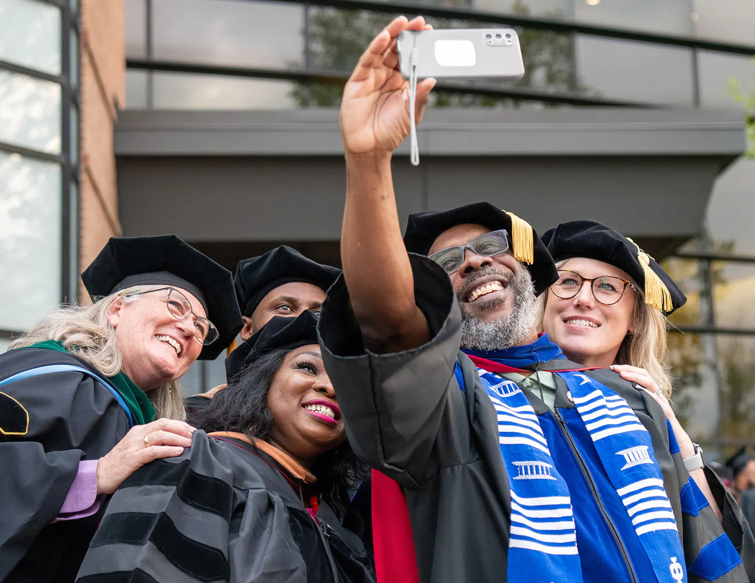 group of graduates posing for selfie