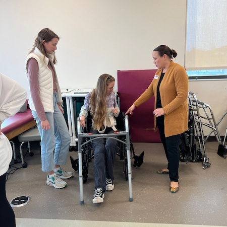 faculty helping student in therapy lab