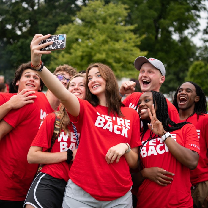IWU students gathered to take a group photo from a cellphone